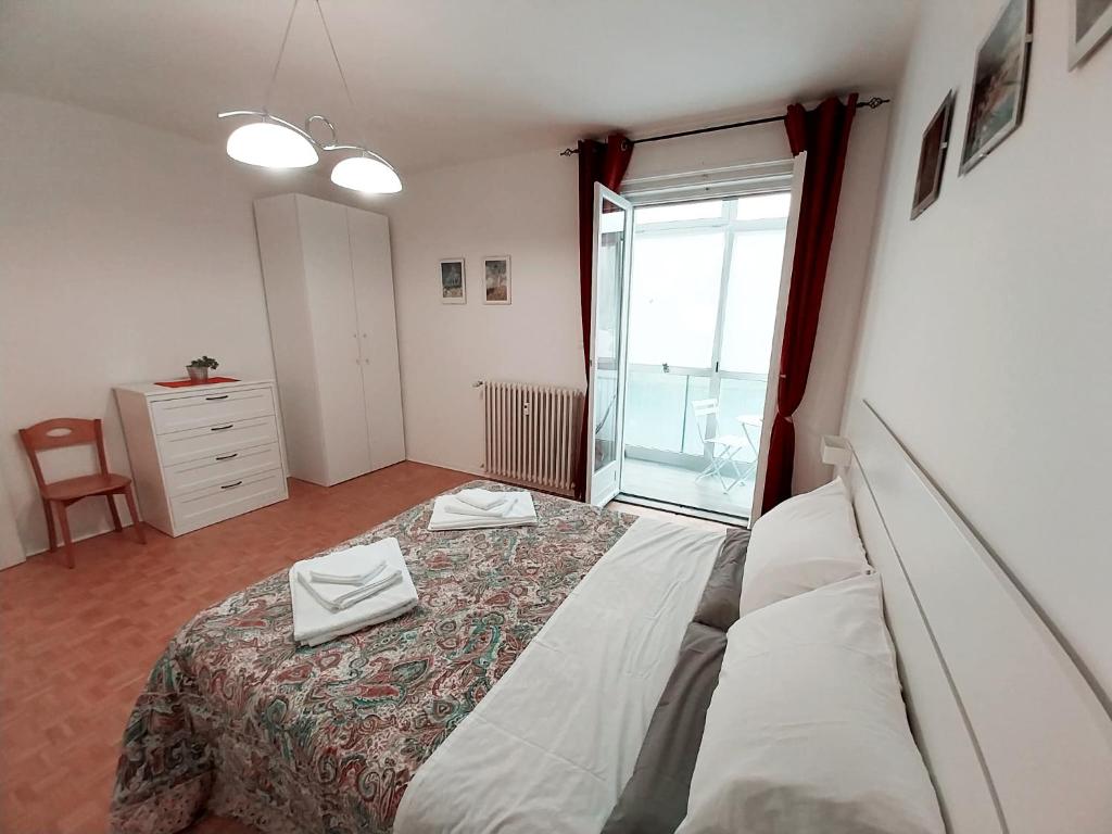 a bedroom with a large bed and a window at Al Giardino Che Non C'è in Trieste