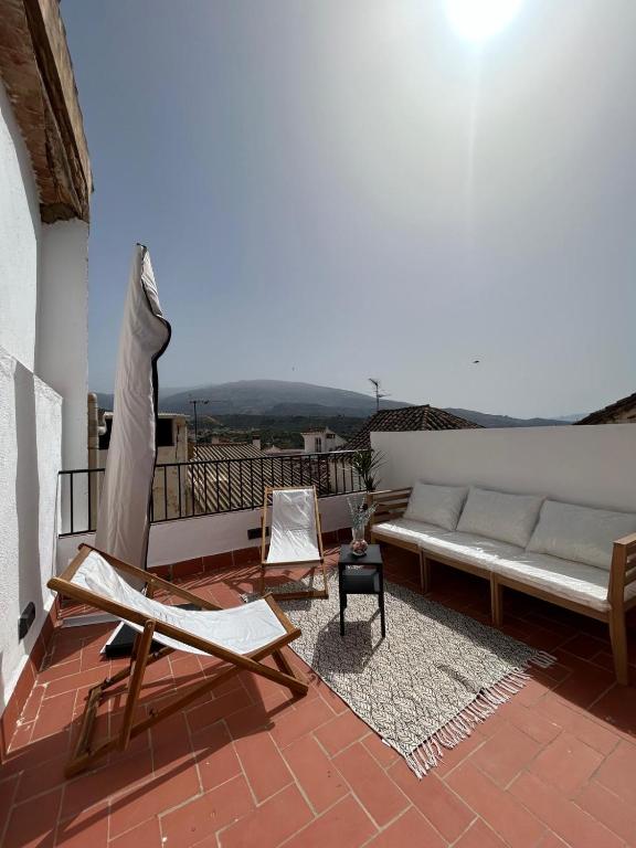 a living room with a couch and chairs on a balcony at Carmen La Golondrina in Restábal