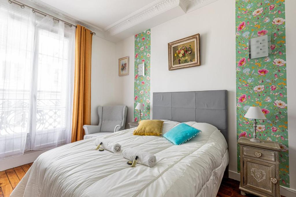 une chambre avec un grand lit et une chaise dans l'établissement GuestReady - Vibrant et confortable à Montparnasse, à Paris
