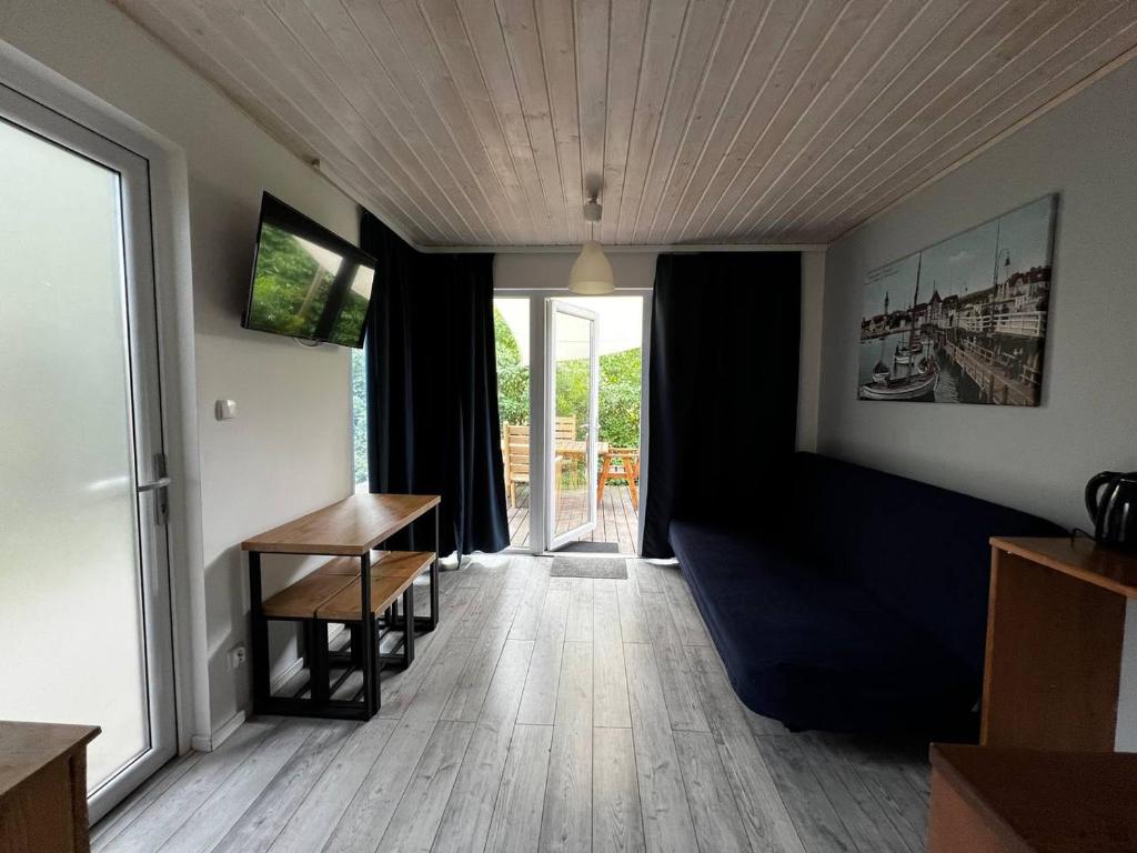a living room with a table and a window at Sopot 34 przy plaży in Sopot
