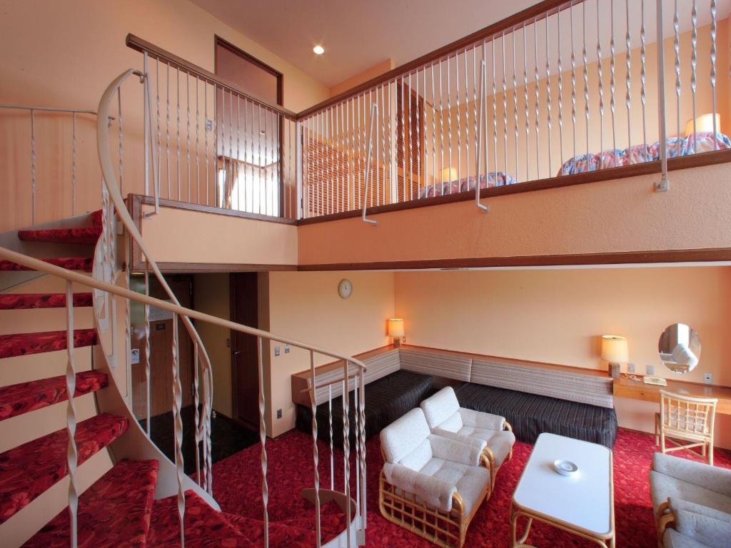 Postel nebo postele na pokoji v ubytování Kamogawa Grand Hotel