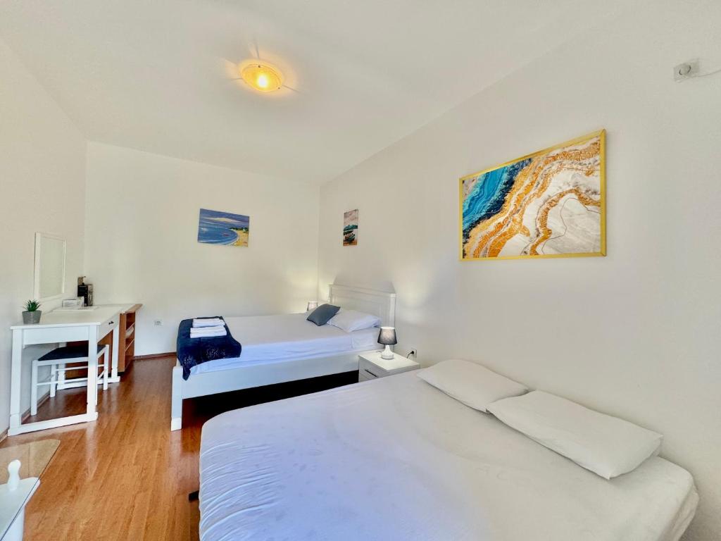 Postel nebo postele na pokoji v ubytování FOR-A Apartmani