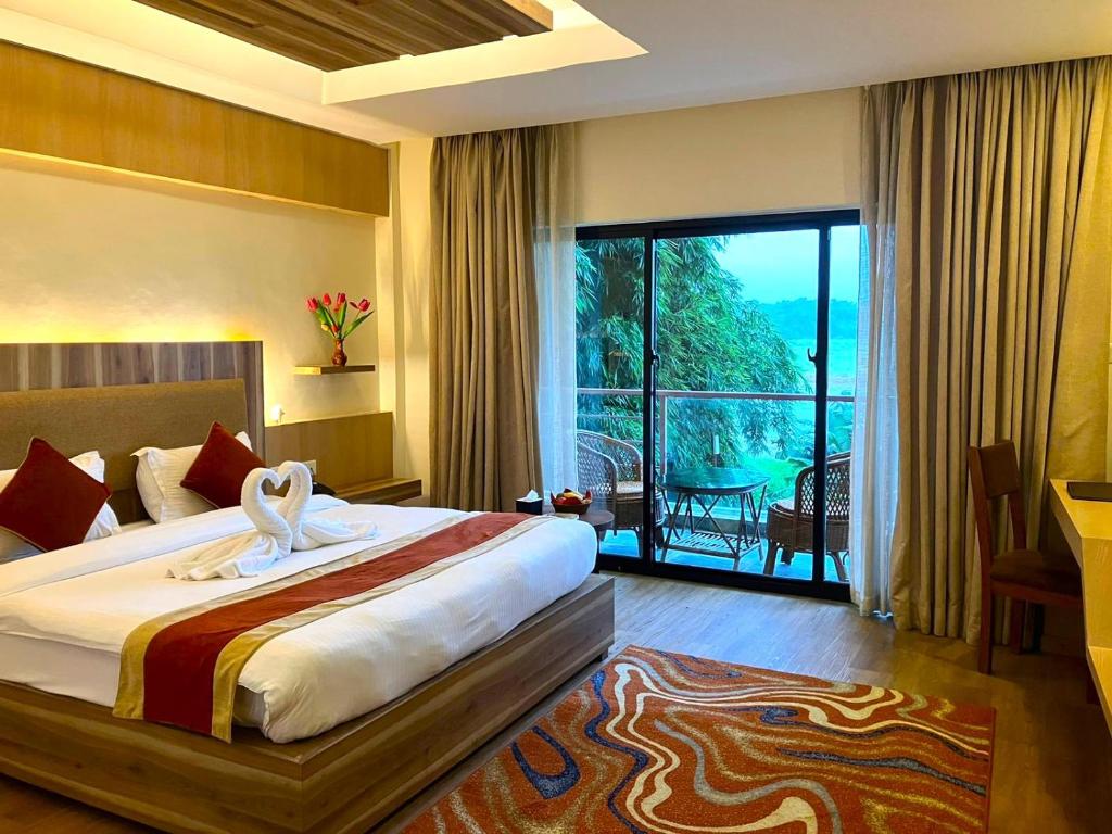 una camera da letto con un letto con vista sull'oceano di Park Safari Resort, Chitwan National Park a Chitwan