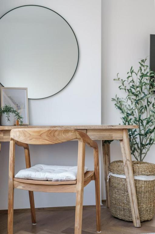 a wooden table with a bench and a mirror at GuestReady - Bohemian Apt with Marina View in Dubai