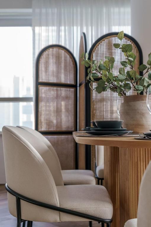 a dining room with two chairs and a table at GuestReady - Bohemian Apt with Marina View in Dubai