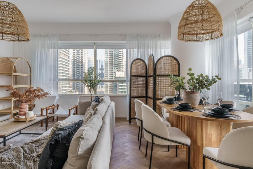 a living room with a couch and a table at GuestReady - Bohemian Apt with Marina View in Dubai