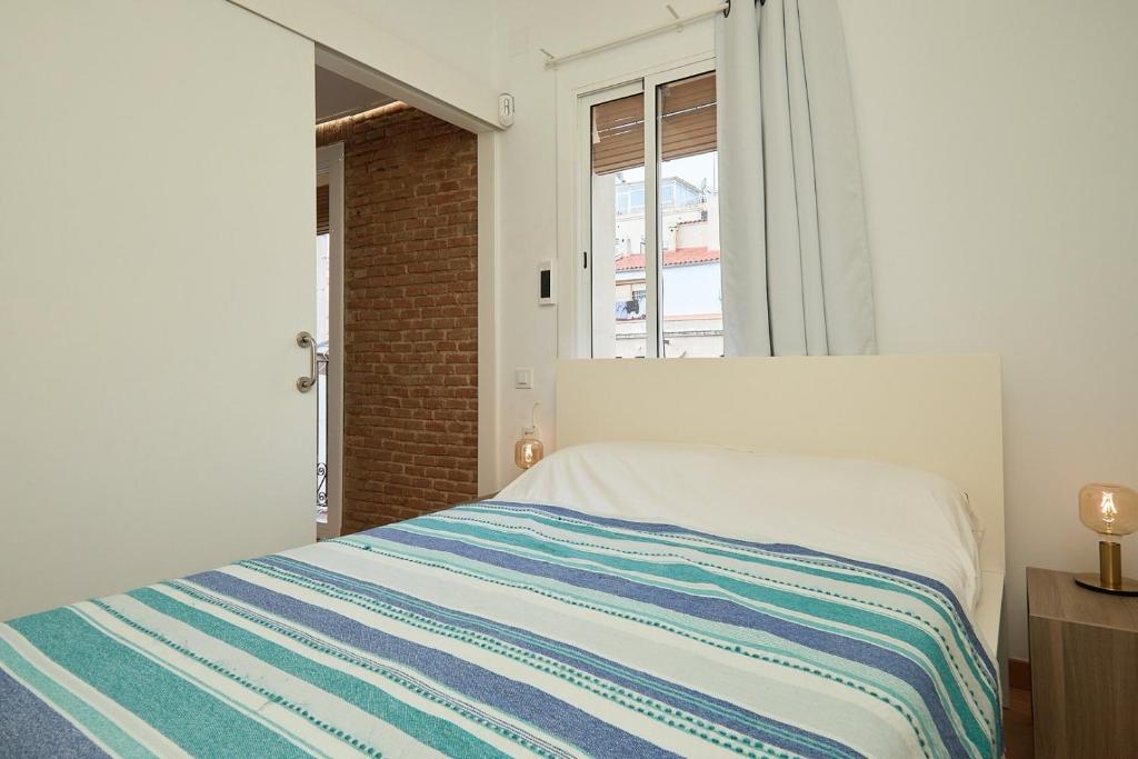 Cama o camas de una habitación en GuestReady - Acogedor Apt en La Barceloneta