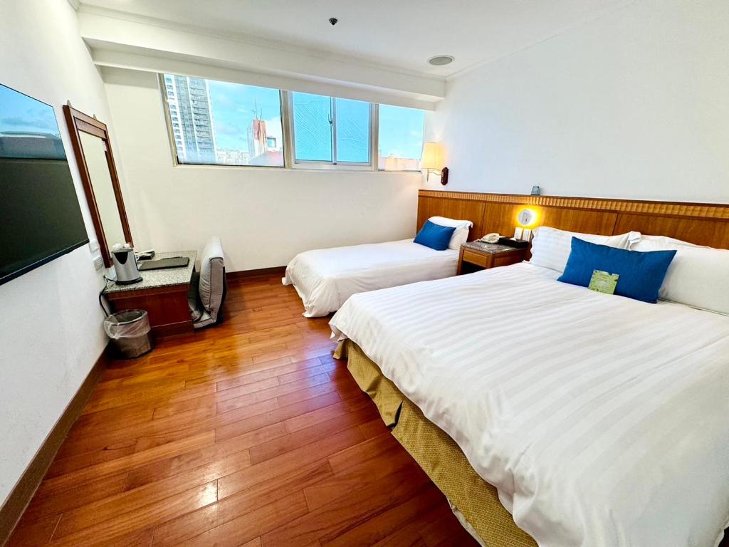 Postel nebo postele na pokoji v ubytování Hub Hotel Kaohsiung Cisian Branch