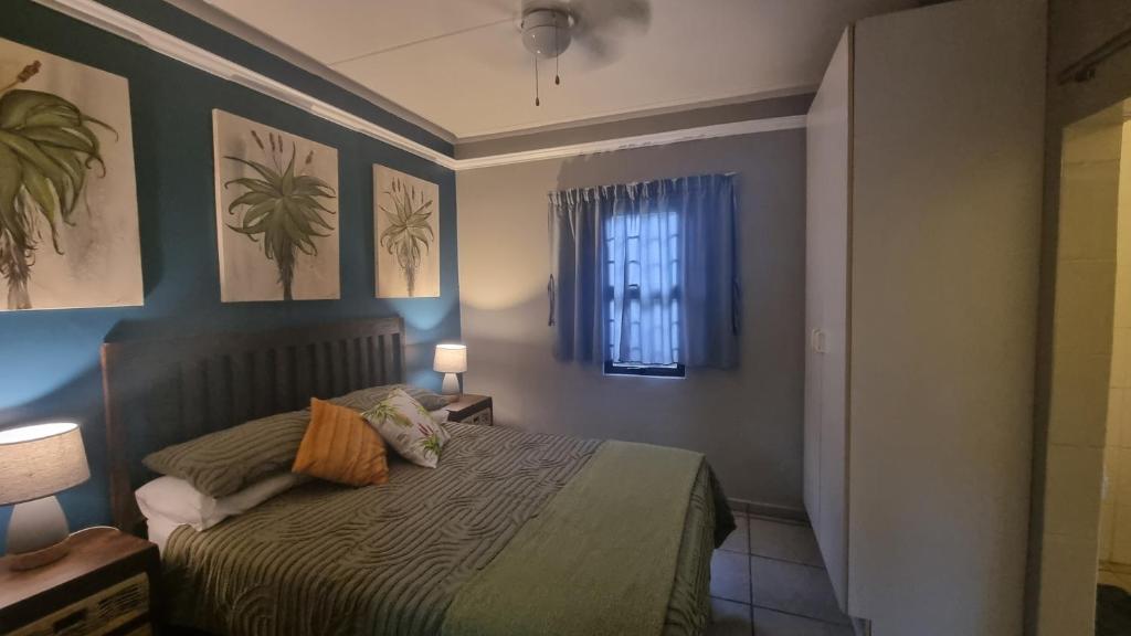 a small bedroom with a bed and a window at Aloe Cottage - Ramsgate Ramble Rest in Margate