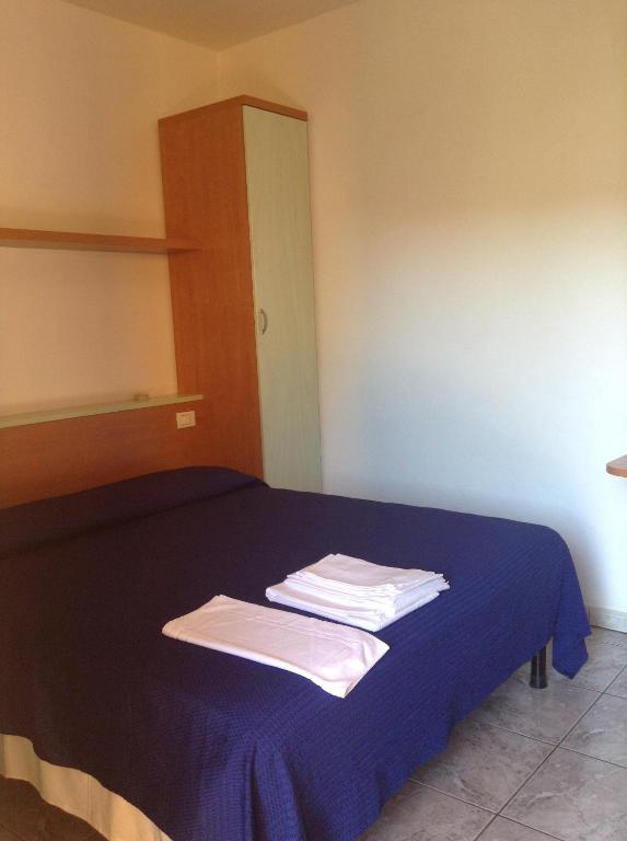 Postel nebo postele na pokoji v ubytování Hotel La Rosa