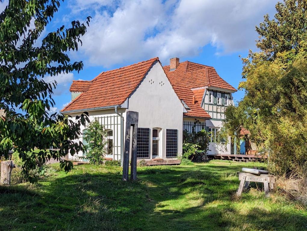 a house with a red roof at Forsthaus Lelkendorf in Lelkendorf