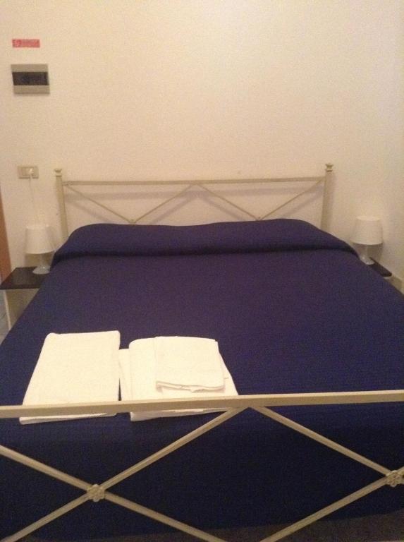 Postel nebo postele na pokoji v ubytování Hotel La Rosa