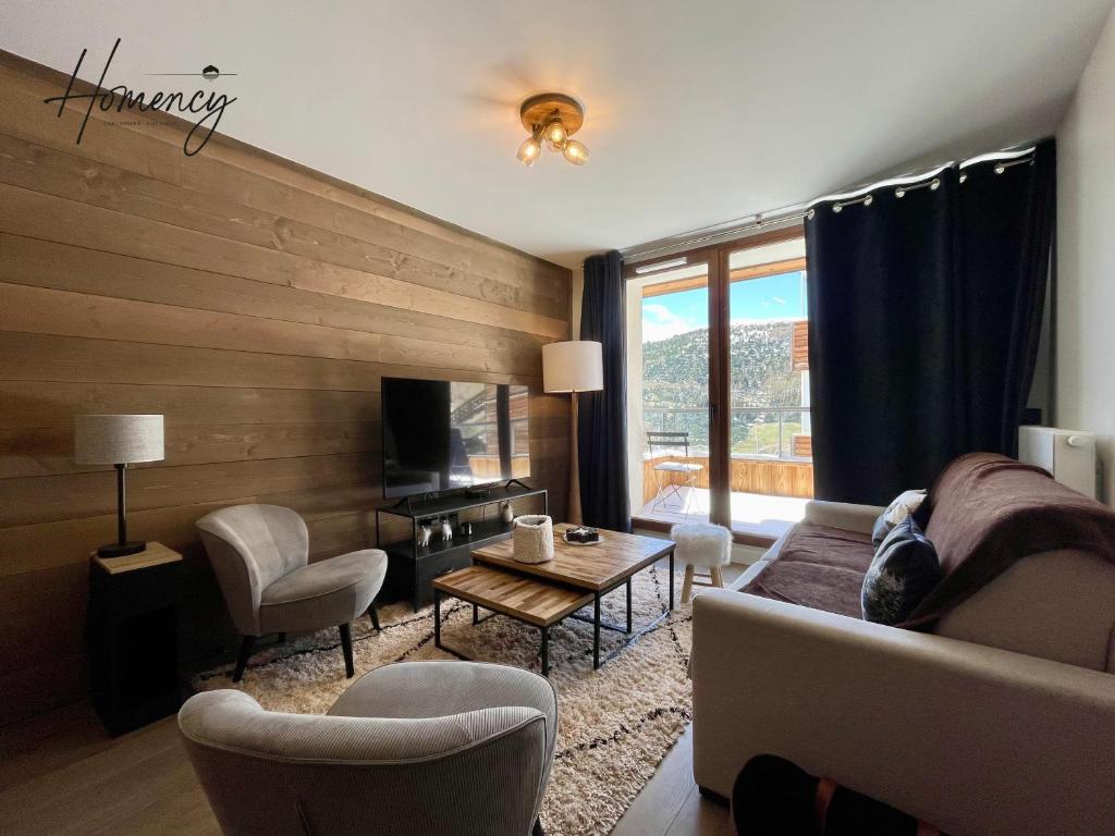 un salon avec un canapé et une table dans l'établissement Homency - Résidence Fermes de l'Alpe D302, à L'Alpe-d'Huez