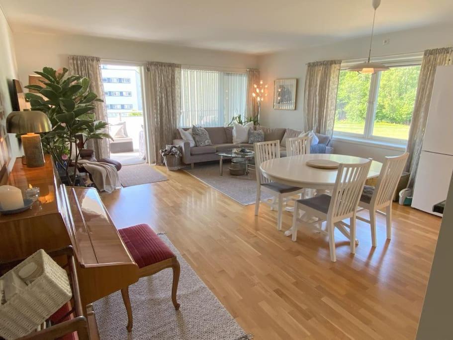 a living room with a table and a couch at Spacious 3 Bedroom next to Thon Hotel, Storsenter Shopping, and 15 minutes to Oslo in Sandvika