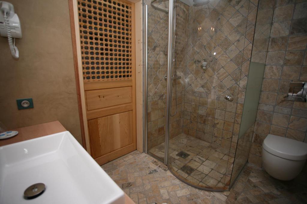 a bathroom with a shower with a toilet and a sink at Hôtel Campo Dell'oro in Ajaccio