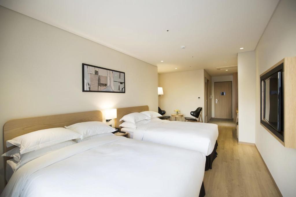 Postel nebo postele na pokoji v ubytování Best Western Haeundae Hotel
