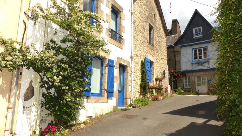 une ruelle avec des fenêtres bleues et un bâtiment dans l'établissement Ravissante maison sur les quais de St Goustan, à Auray