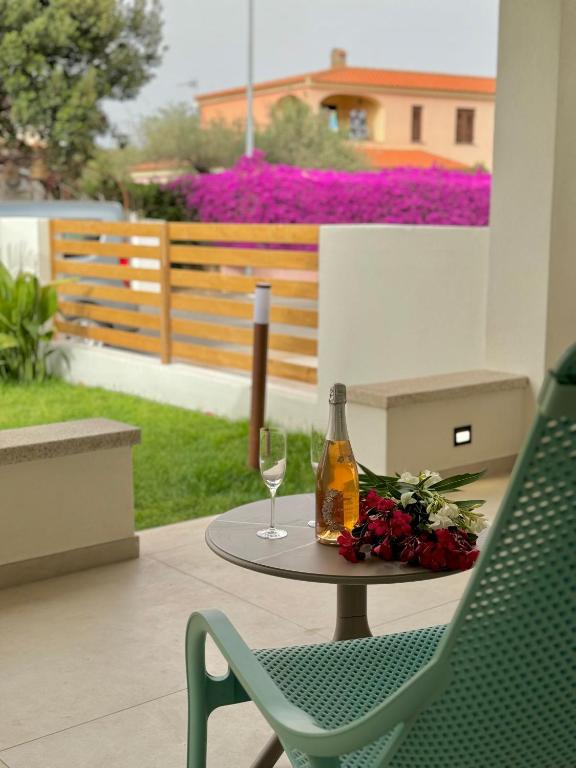 a table with a bottle of wine and a glass at Villa Berenike in San Teodoro