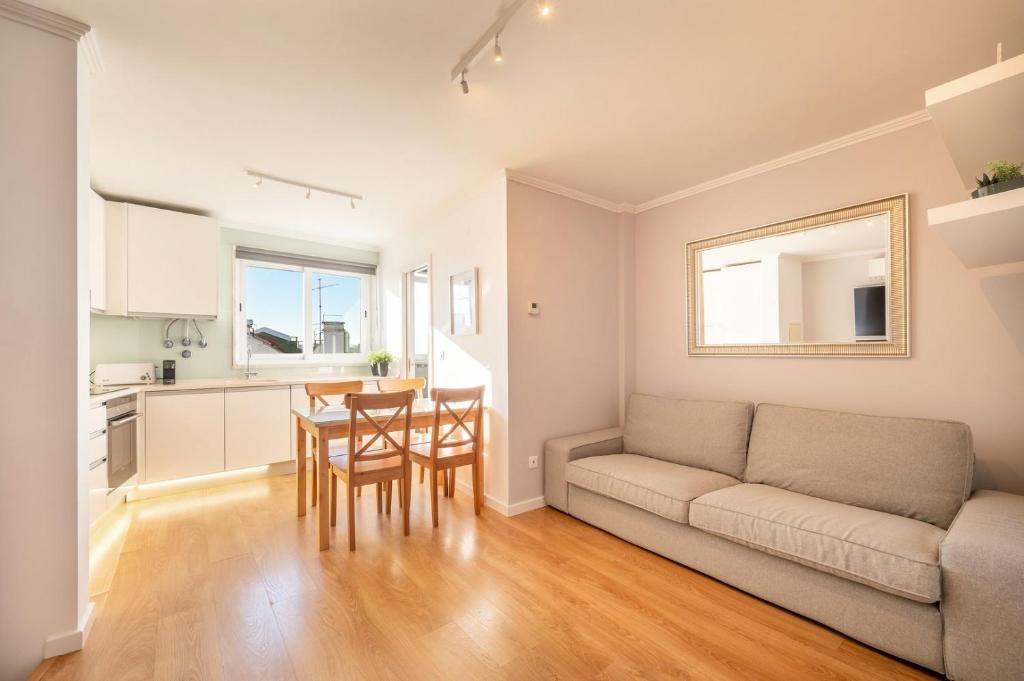 a living room with a couch and a table at GuestReady - Sunny spacious in Belém in Lisbon