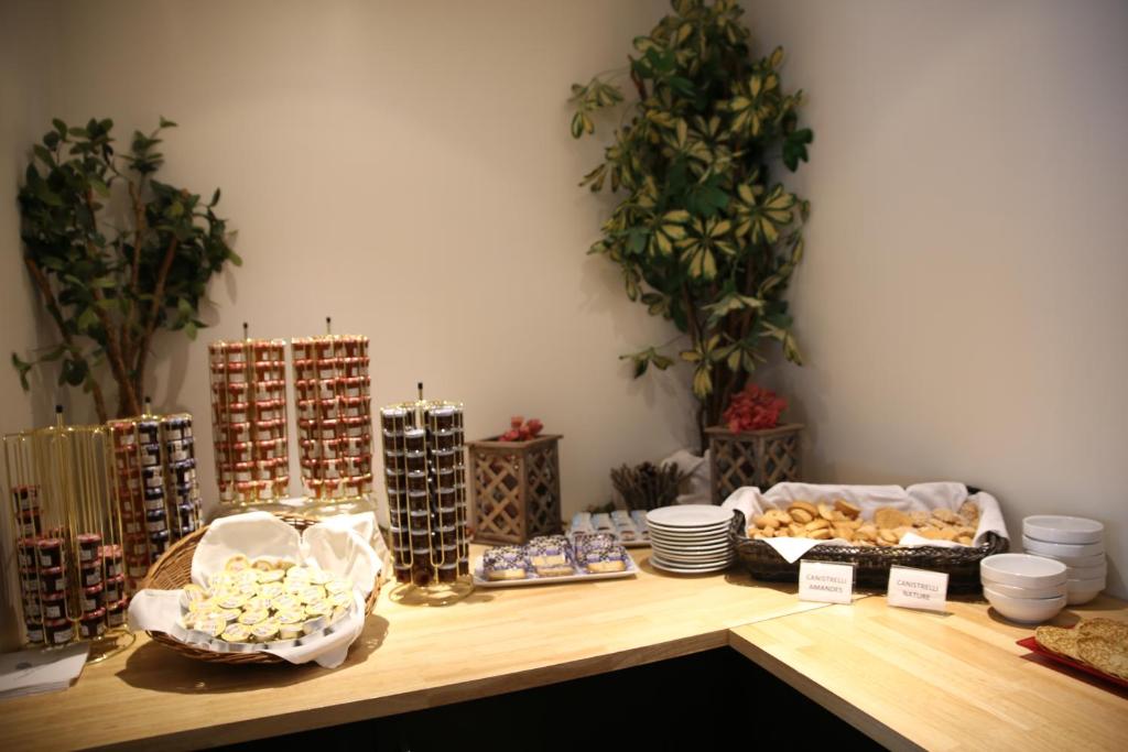 a table with a bunch of food on it at Hôtel Campo Dell'oro in Ajaccio