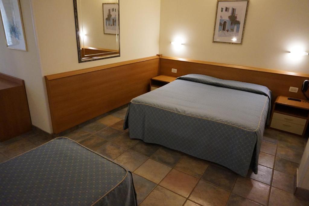 Postel nebo postele na pokoji v ubytování Hotel Angela