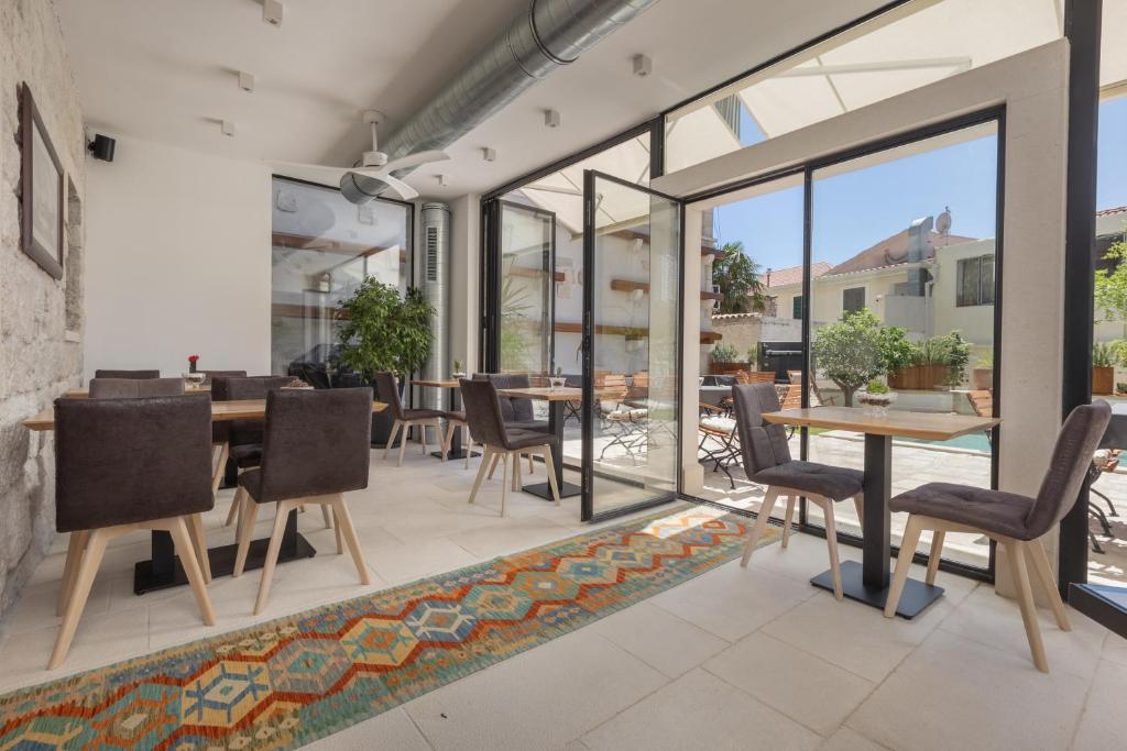 an open dining room with a table and chairs at NEW - Casa Columba - 4 Star Design Boutique Hotel with Outdoor Pool & Private Garden in Makarska