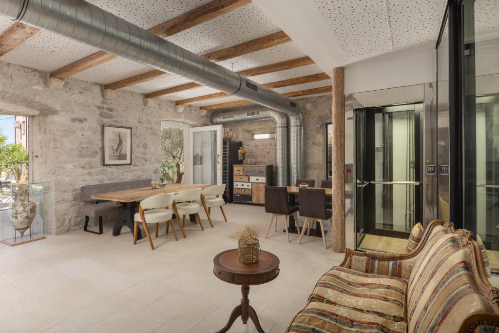 an open living room with a table and chairs at NEW - Casa Columba - 4 Star Design Boutique Hotel with Outdoor Pool & Private Garden in Makarska