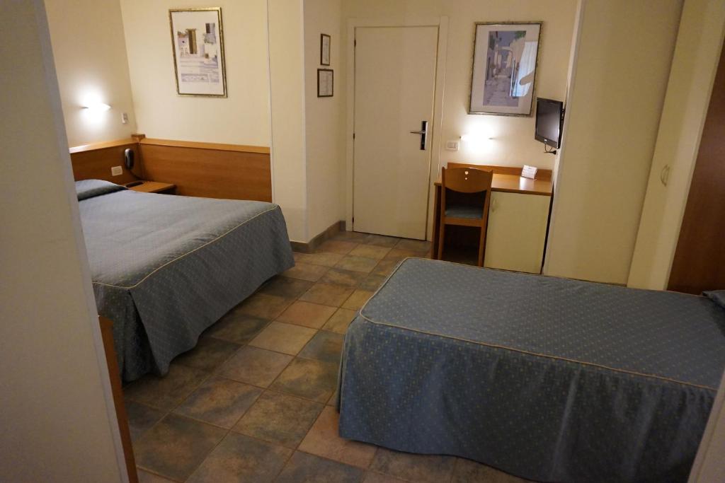 Postel nebo postele na pokoji v ubytování Hotel Angela