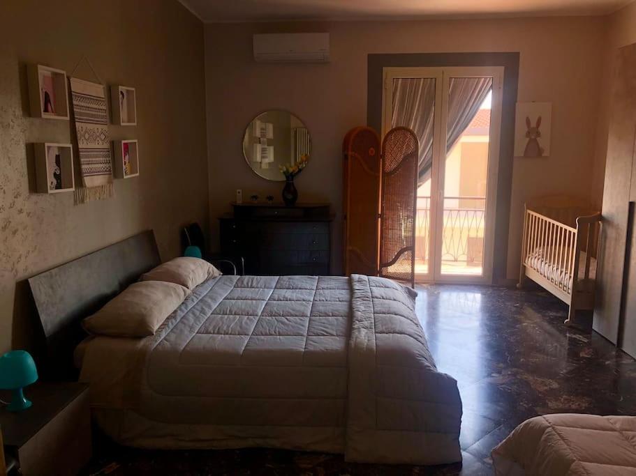 a bedroom with a large bed and a sliding glass door at Casa vacanze Conte in Sannicandro di Bari