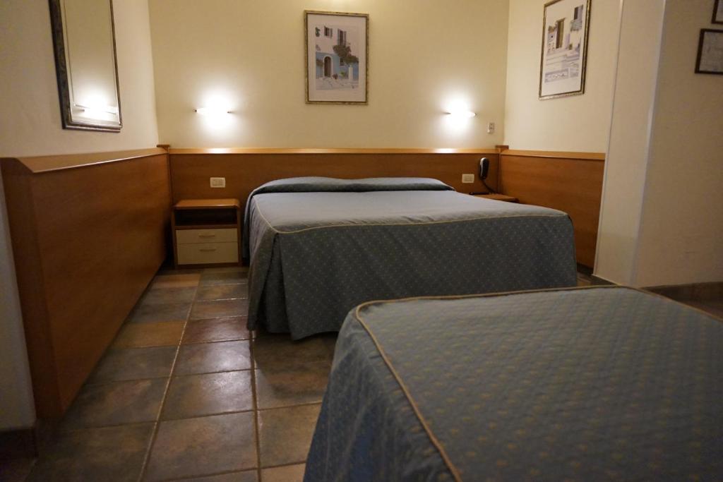 Postel nebo postele na pokoji v ubytování Hotel Angela