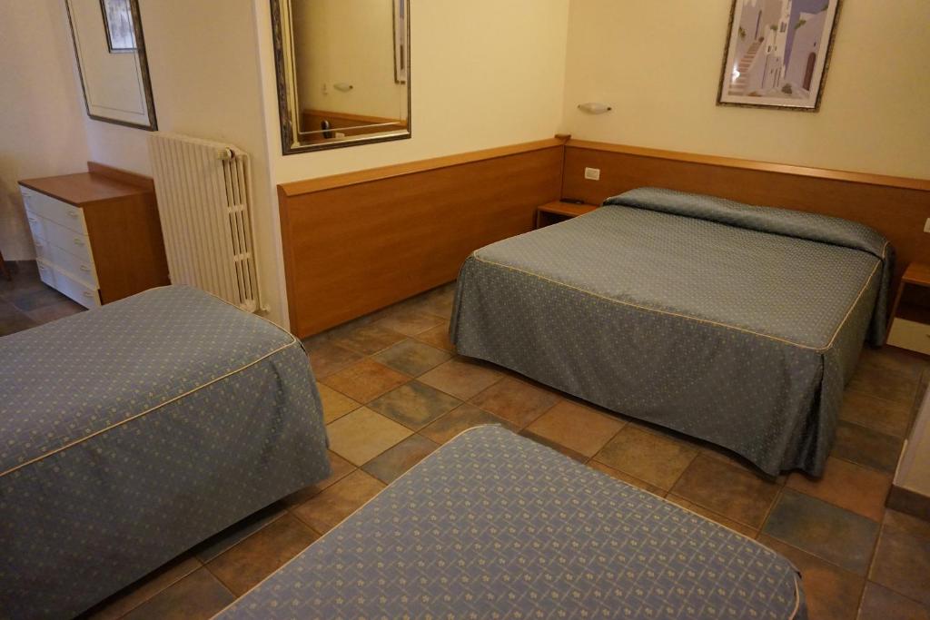 Postel nebo postele na pokoji v ubytování Hotel Angela