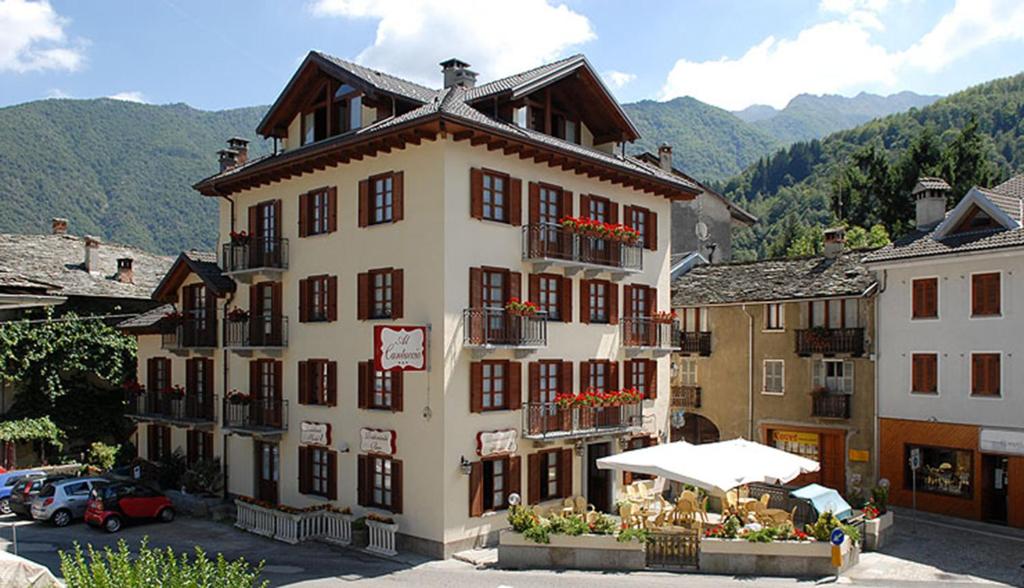 a large building with flowers in front of it at Al Cantuccio in Scopello