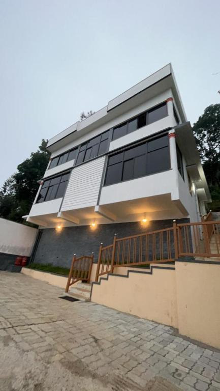 a house with a lot of windows on it at Dream Casa in Anachal