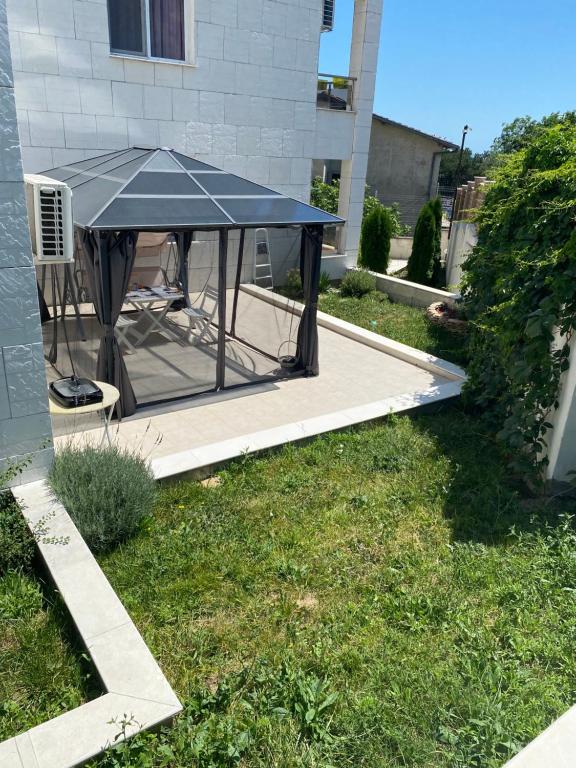 Una mesa de picnic negra en una terraza. en Byala Leisure Place, en Byala
