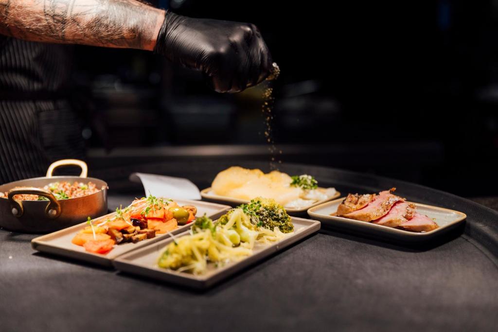 a person is preparing food on a table at Holzhotel Forsthofalm in Leogang