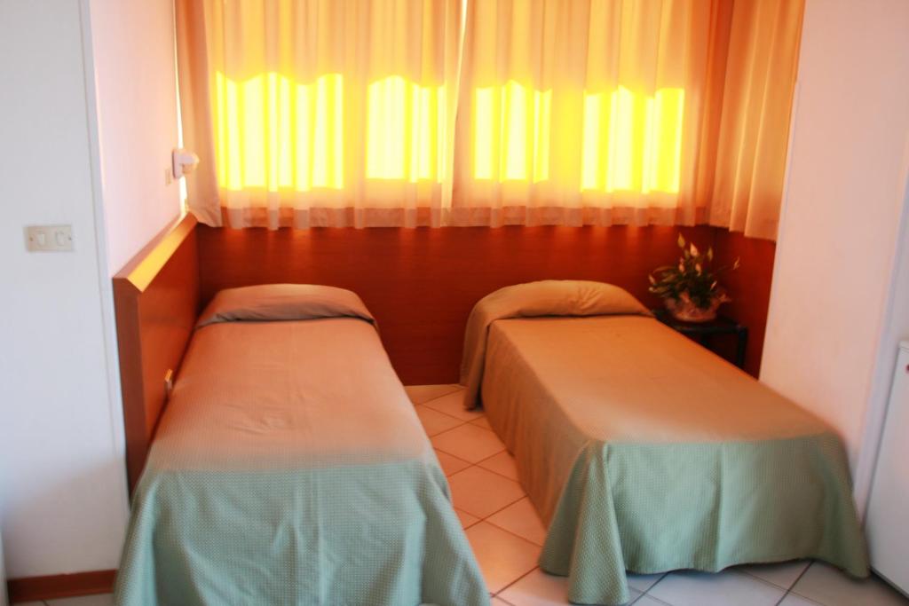 Postel nebo postele na pokoji v ubytování Hotel Excelsior