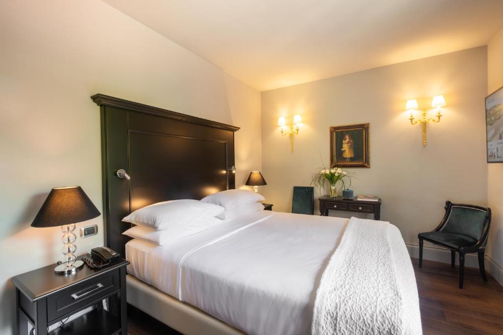 Postel nebo postele na pokoji v ubytování Hotel Vannucci
