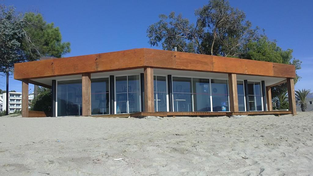 a house on the beach with glass at Hôtel Campo Dell'oro in Ajaccio