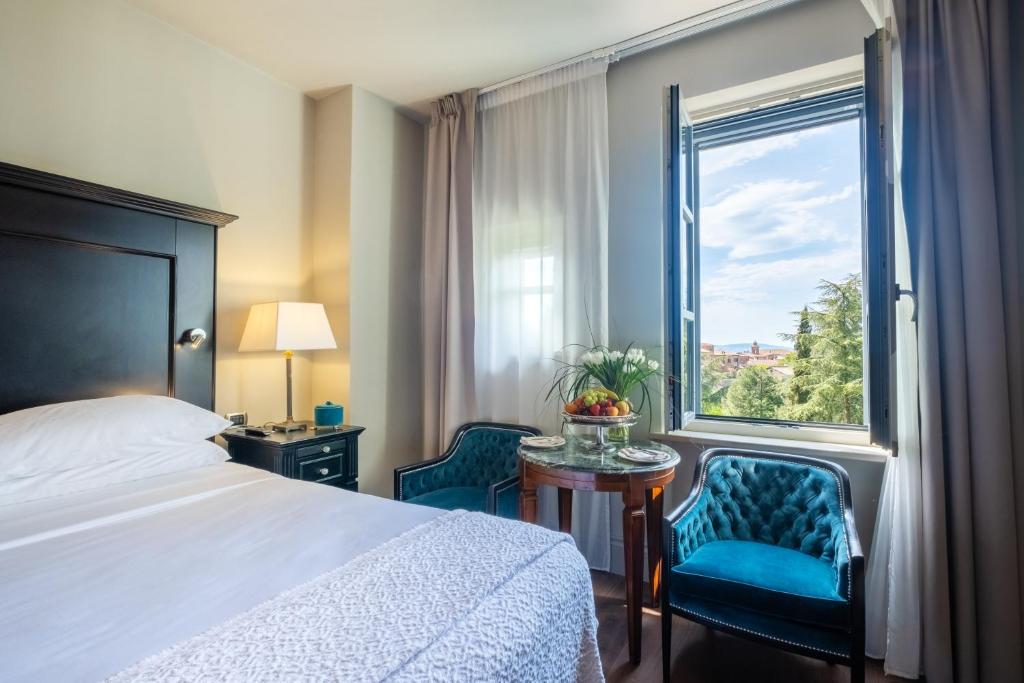 Postel nebo postele na pokoji v ubytování Hotel Vannucci
