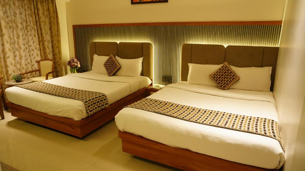 Postel nebo postele na pokoji v ubytování Hotel Ganpati Palace Shirdi Newly Renovated