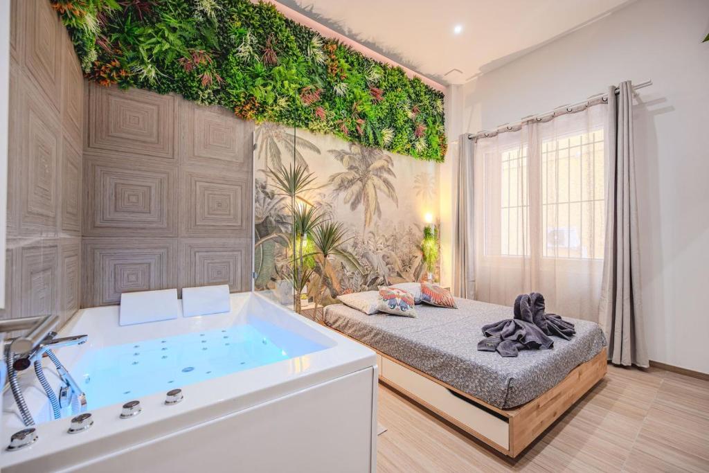 a bathroom with a tub and a bed and a bath room at Little Bangkok - Luxury SPA Apartment in Toulon