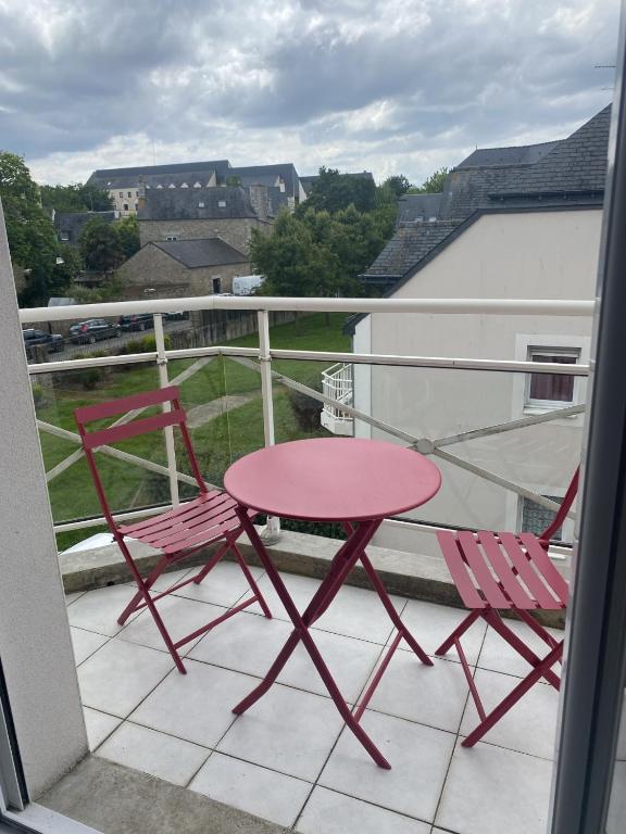 deux chaises et une table rose sur un balcon dans l'établissement appartement Dinan, à Dinan