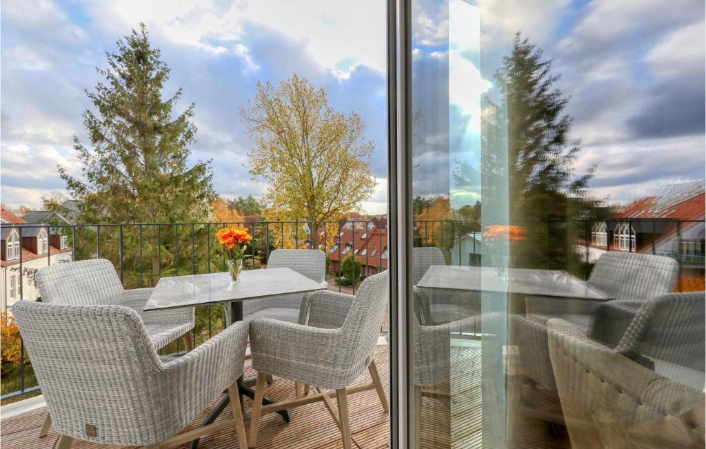 a patio with a table and chairs on a balcony at Baltischer Hof Apartment 66 in Boltenhagen