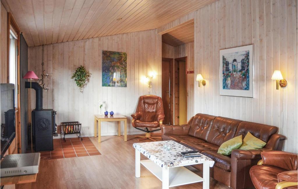 a living room with a leather couch and a table at 4 Bedroom Stunning Home In Thisted in Thisted