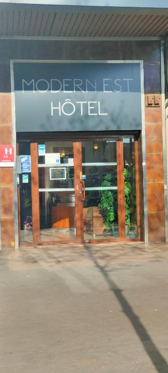 a hotel with a sign on the front of it at Hotel Modern Est in Paris