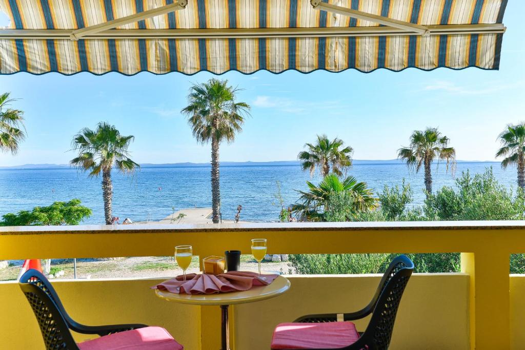 a table with two chairs and a view of the ocean at Apartment house Inga in Vir