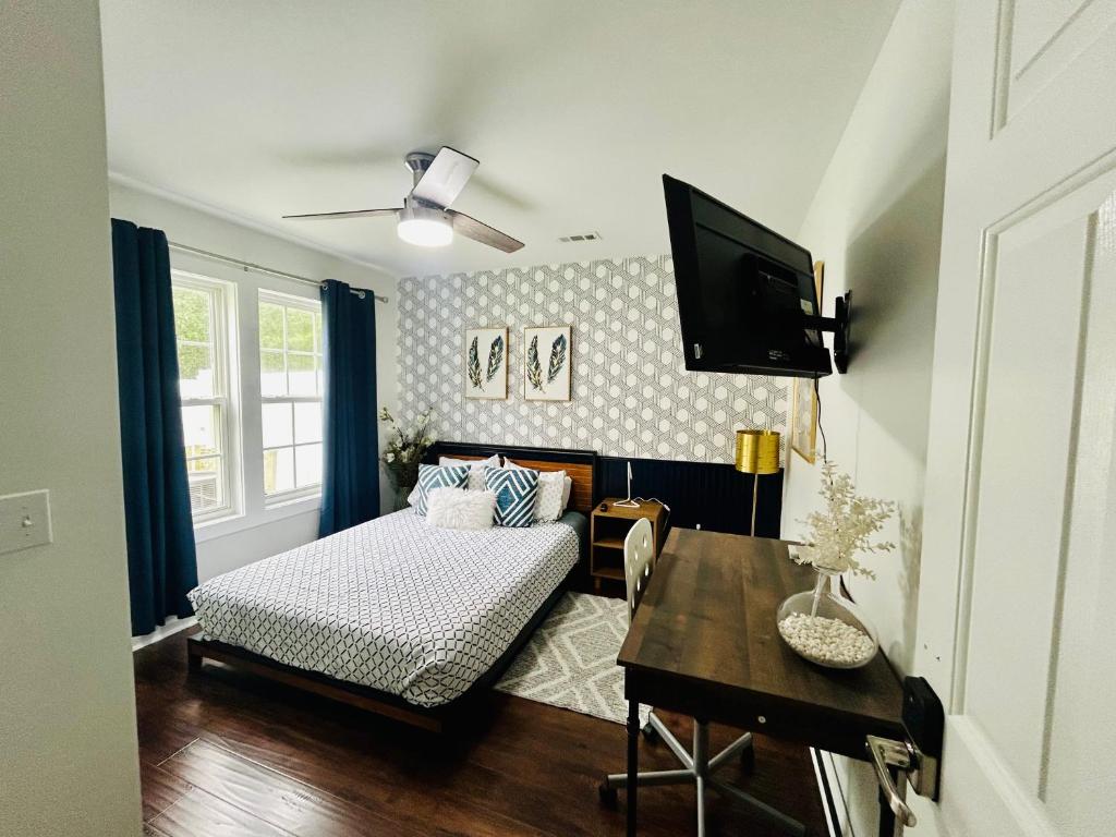 a bedroom with a bed and a tv in a room at Cozy Bedroom Suites in Beautiful Shared Home in Matthews