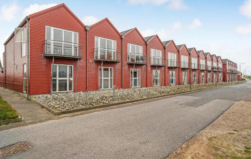 a row of red houses on the side of a street at Three-Bedroom Holiday Home In Ulfborg in Ulfborg