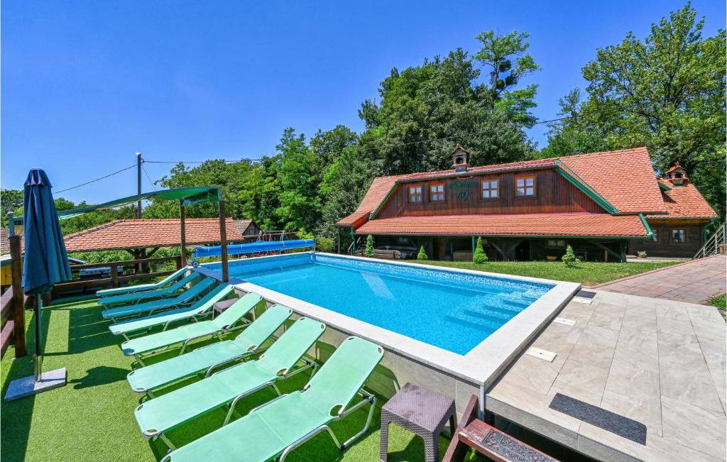 a swimming pool with lounge chairs and a house at Nice Home In Klanjec With Sauna in Klanjec