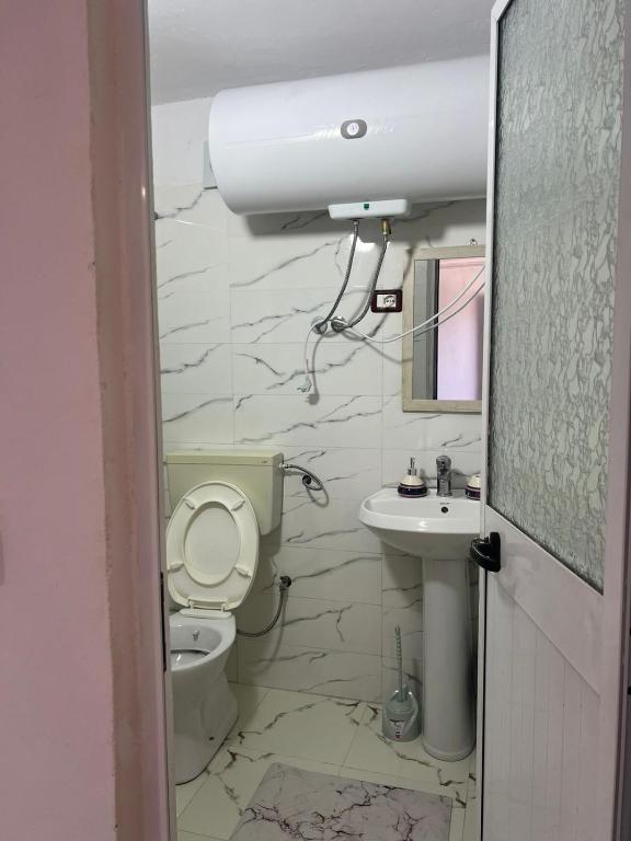 een badkamer met toilet en wastafel bij Welcome Guest House in Shkodër